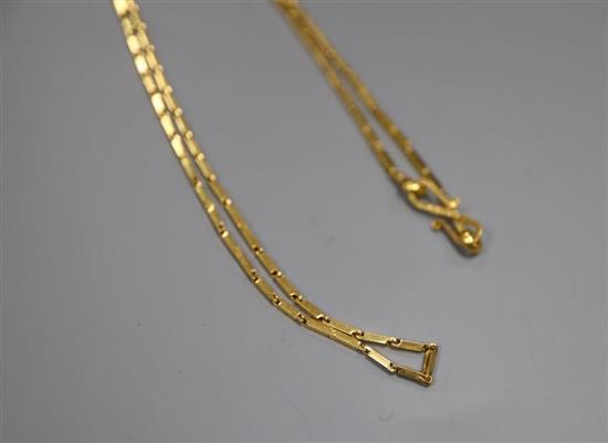 A yellow metal long bar link fine chain, possibly Middle Eastern (tests as 18ct gold), 8.7g